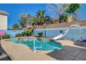 Backyard pool with water slide and painted block wall offers hours of fun in the sun at 3832 Alder Creek Ct, North Las Vegas, NV 89032