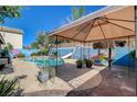 Poolside view with shaded gazebo offers the perfect spot to relax and enjoy the backyard's aquatic fun at 3832 Alder Creek Ct, North Las Vegas, NV 89032