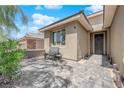 Cozy front entrance with a tiled patio, comfortable seating, and attractive landscaping; warm welcome at 40 Vicolo Della Luna, Henderson, NV 89011
