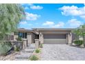 Beautiful single-story home with a two-car garage, stone walkway, and well-maintained front yard landscaping at 40 Vicolo Della Luna, Henderson, NV 89011