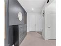 Contemporary entryway with tile flooring, decorative wall, and storage cabinet at 4246 W Landberg Ave, Las Vegas, NV 89141