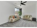 Bright living room features neutral paint, carpeted floors, and comfortable sofas at 4246 W Landberg Ave, Las Vegas, NV 89141