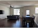 Open-concept living area with hardwood floors, natural light, and modern furnishings at 4554 Townwall St, Las Vegas, NV 89115