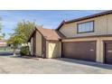 Exterior view of the townhome featuring an attached 2-car garage and well-kept landscape at 4571 Sirius Ave, Las Vegas, NV 89102