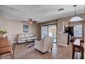 Cozy living room with neutral walls, access to balcony, and open to the kitchen at 4860 Nara Vista Way # 204, Las Vegas, NV 89103