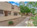 Attractive townhome exterior with a walkway and desert landscaping leading to a private entrance at 5029 Spencer St # D, Las Vegas, NV 89119