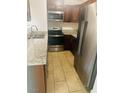 Kitchen features modern stainless appliances, granite countertops, and cherry cabinets at 5029 Spencer St # D, Las Vegas, NV 89119