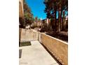 Enclosed patio featuring block fence with white trim, concrete pavers, and partial shade at 5029 Spencer St # D, Las Vegas, NV 89119
