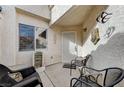 Cozy front porch with seating area, decorative elements, and a secure front entrance at 5171 Briar Patch Way, Las Vegas, NV 89118