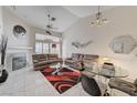 Bright living room with modern furnishings, fireplace, and large windows for ample natural light at 5171 Briar Patch Way, Las Vegas, NV 89118