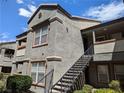 Apartment exterior featuring a stairway to the second level, complemented by tidy landscaping at 555 E Silverado Ranch Blvd # 2147, Las Vegas, NV 89183