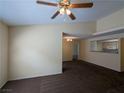 Neutral living room featuring a ceiling fan and opening to a kitchen bar area at 555 E Silverado Ranch Blvd # 2147, Las Vegas, NV 89183