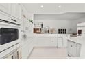 Bright kitchen features white cabinets, stainless steel appliances and a kitchen island at 6141 Markleham Ave, Las Vegas, NV 89130