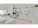 Bright kitchen features white cabinets, stainless steel appliances and a kitchen island at 6141 Markleham Ave, Las Vegas, NV 89130