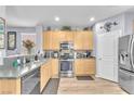 Beautiful kitchen with stainless steel appliances, light wood cabinets, and modern backsplash at 7115 Hickory Post Ave, Las Vegas, NV 89179