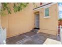 Side view of a front entrance featuring a secured doorway and small yard at 7331 Carrot Ridge St, Las Vegas, NV 89139