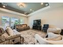 Spacious living room with recessed lighting, large windows, and comfortable neutral-toned furniture at 7340 Zonal Ave, Las Vegas, NV 89131