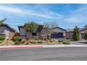 Inviting home with rock accents, desert landscaping, and a paved driveway at 7416 Deschutes Cir, Las Vegas, NV 89129