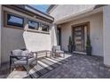 Welcoming patio with modern seating and stylish front door at 7416 Deschutes Cir, Las Vegas, NV 89129