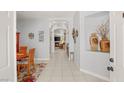 Inviting entryway with tile floors, neutral walls, and a view into the living room with a fireplace at 7736 Foredawn Dr, Las Vegas, NV 89123