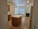 Spacious living area with fireplace, tile flooring, and adjacent kitchen island at 7849 Blue Brook Dr, Las Vegas, NV 89147