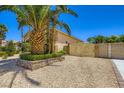 Well-maintained front yard features desert landscaping and an ornate gate at 8078 Leather Harness St, Las Vegas, NV 89131