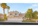 Charming two-story house with a well-manicured lawn, mature trees, and a three-car garage at 8100 Lake Hills Dr, Las Vegas, NV 89128