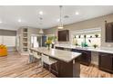Bright kitchen featuring an island with counter seating, stylish pendant lighting, and modern appliances at 8100 Lake Hills Dr, Las Vegas, NV 89128