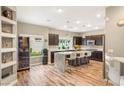 Modern kitchen featuring stainless steel appliances, a marble island with seating, and sleek dark cabinetry at 8100 Lake Hills Dr, Las Vegas, NV 89128