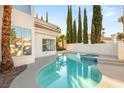 Beautiful backyard pool and hot tub area with well-maintained landscaping and privacy at 8100 Lake Hills Dr, Las Vegas, NV 89128