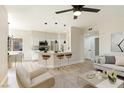Open-concept living area showcasing light wood floors and a kitchen with a breakfast bar at 8501 W University Ave # 1042, Las Vegas, NV 89147