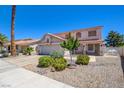 Charming two-story home featuring a tile roof, a two-car garage, and well-maintained landscaping at 982 Flapjack Dr, Henderson, NV 89014