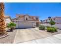 Charming two-story home featuring a tile roof, a two-car garage, and well-maintained landscaping at 982 Flapjack Dr, Henderson, NV 89014