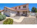 Charming two-story home featuring a tile roof, a two-car garage, and well-maintained landscaping at 982 Flapjack Dr, Henderson, NV 89014