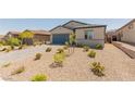 Single-story home with a xeriscaped front yard and a two-car garage at 10257 Sequoia Falls Pl, Las Vegas, NV 89149