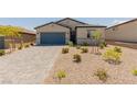 Single-story home showcasing desert landscaping, gray accents, and a two-car garage at 10257 Sequoia Falls Pl, Las Vegas, NV 89149