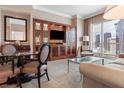Cozy living area features refined seating, elegant built-ins, and breathtaking city views from the large windows at 125 E Harmon Ave # 321, Las Vegas, NV 89109