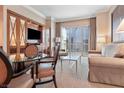Comfortable living room boasts plush seating, modern decor, and city views from the large sliding glass doors at 125 E Harmon Ave # 321, Las Vegas, NV 89109