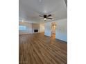 Inviting living area with wood floors, ceiling fan, and access to the kitchen at 131 Copper St, Henderson, NV 89015