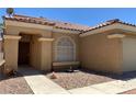 Welcoming front view of home featuring low maintenance desert landscaping, walkway, and covered entrance at 1712 Matador Way, Las Vegas, NV 89128