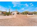A modest single story home with desert landscaping and mature foliage at 1733 N Michael Way, Las Vegas, NV 89108