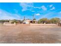 Wide angle shot of a modest single story home with desert landscaping and mature foliage at 1733 N Michael Way, Las Vegas, NV 89108