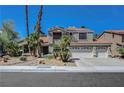 Charming two-story home showcasing manicured landscaping and a spacious three-car garage at 2016 Catalina Marie Ave, Henderson, NV 89074