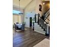 View of foyer, formal dining area, and staircase, with dark wood floors and high ceilings at 2016 Catalina Marie Ave, Henderson, NV 89074