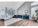 Comfortable living room featuring vaulted ceiling, large windows, and modern decor at 2016 Catalina Marie Ave, Henderson, NV 89074