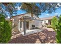 Serene backyard featuring a covered patio and lush greenery, perfect for outdoor enjoyment at 2158 Indigo Creek Ave, Henderson, NV 89012