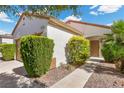 Inviting front yard with lush landscaping and a walkway leading to the charming entrance at 2158 Indigo Creek Ave, Henderson, NV 89012