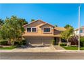 Lovely two-story home with a well-manicured lawn, mature trees, and a two-car garage at 2232 Le Conte Ave, Henderson, NV 89074