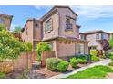 Charming two-story stucco home with a small balcony, red tile roof, and a gated side entrance at 2432 Granada Bluff Ct, Las Vegas, NV 89135