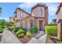 Charming stucco home with red tile roof, manicured landscaping, and sidewalk leading to the front door at 2432 Granada Bluff Ct, Las Vegas, NV 89135